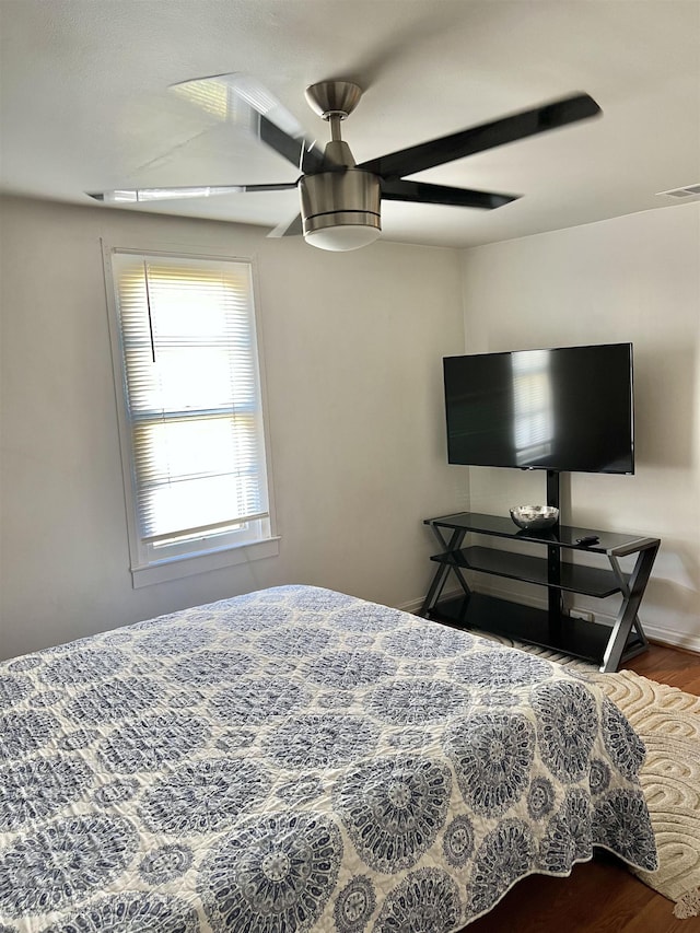 bedroom with ceiling fan and wood-type flooring