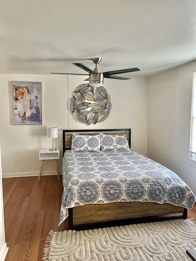 bedroom with hardwood / wood-style flooring and ceiling fan