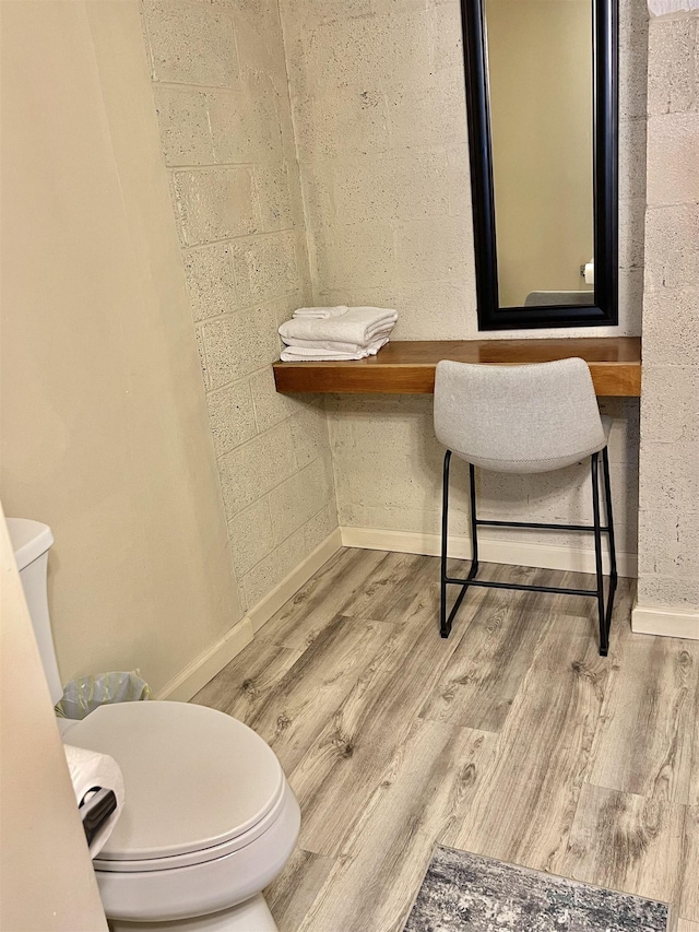 bathroom featuring hardwood / wood-style floors and toilet