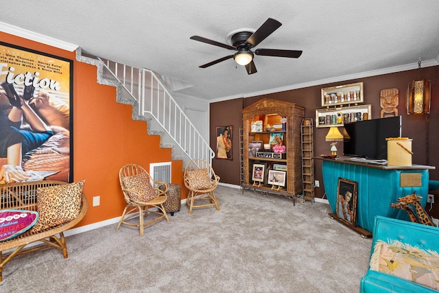 sitting room with carpet flooring, crown molding, and a textured ceiling