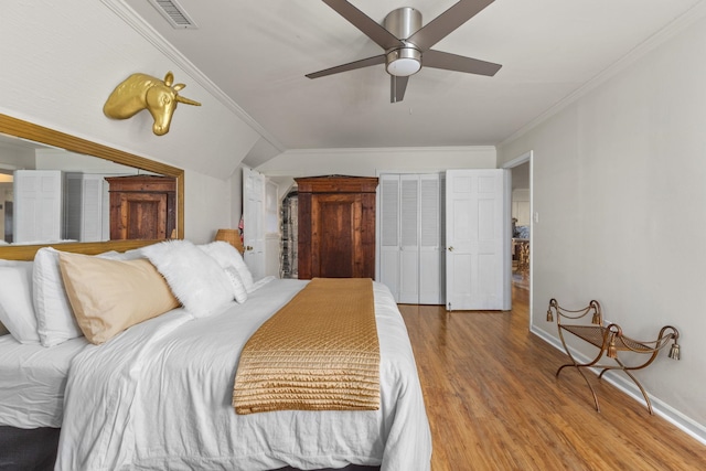 bedroom with hardwood / wood-style flooring, ceiling fan, and ornamental molding