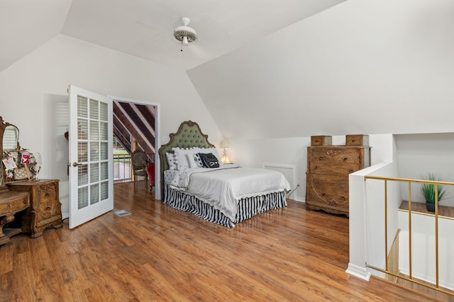 bedroom featuring hardwood / wood-style floors, ceiling fan, and vaulted ceiling