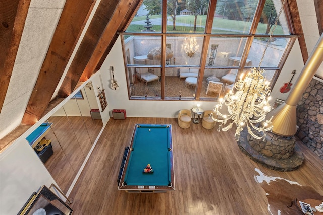 interior space featuring hardwood / wood-style floors, an inviting chandelier, and pool table