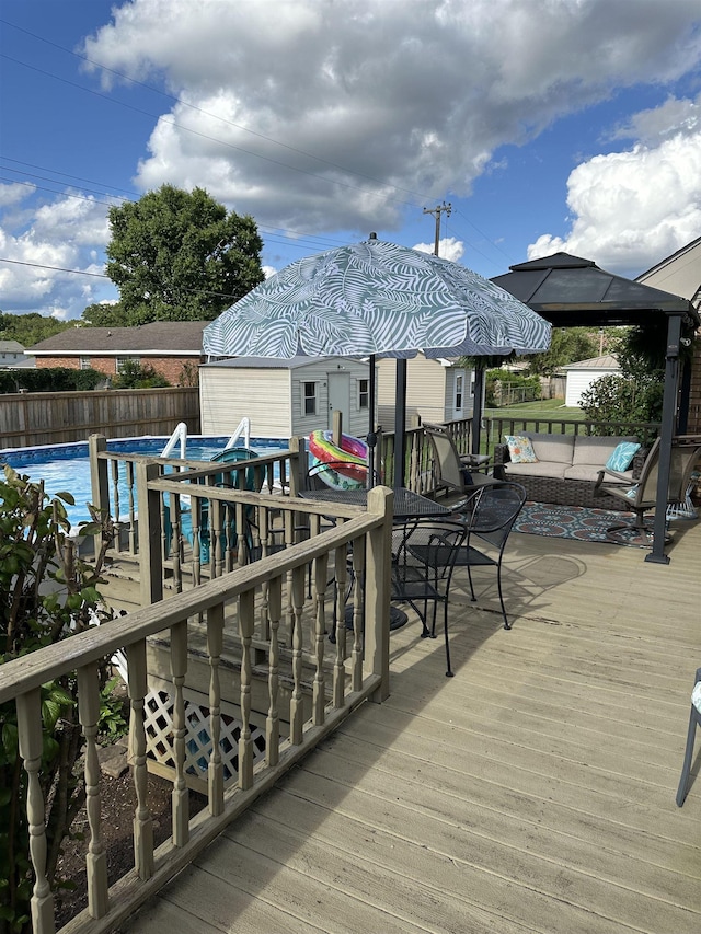  - deck featuring a fenced backyard and outdoor lounge area