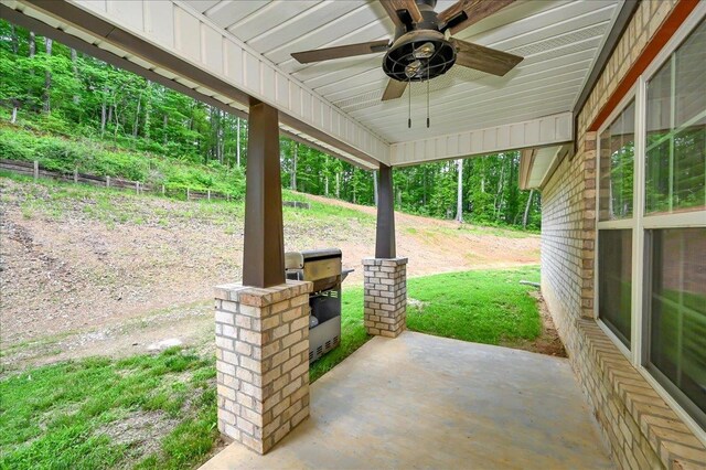  - view of patio featuring ceiling fan