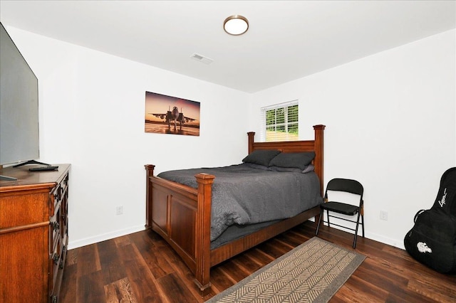  - bedroom featuring dark wood-type flooring and baseboards