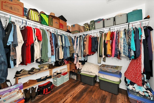  - walk in closet with wood finished floors