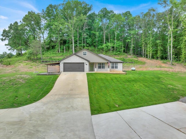  - view of front of house featuring concrete driveway, brick siding, a garage, and a front yard