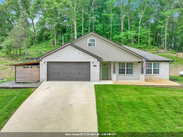 - view of front of property with a garage, brick siding, concrete driveway, and a front yard