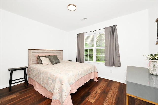  - bedroom featuring wood finished floors and baseboards