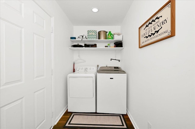  - laundry area with washing machine and dryer, dark wood finished floors, and baseboards