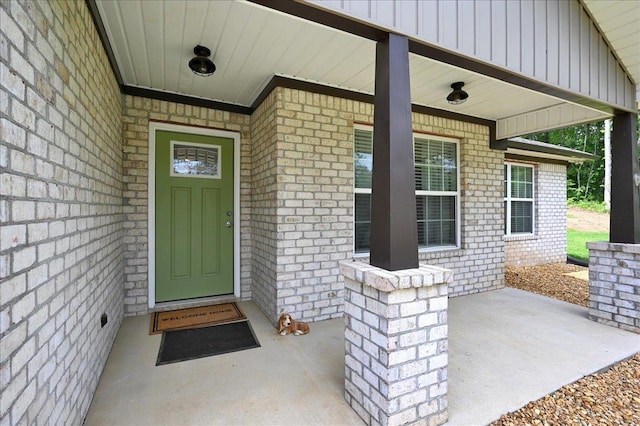  - entrance to property featuring a porch and brick siding