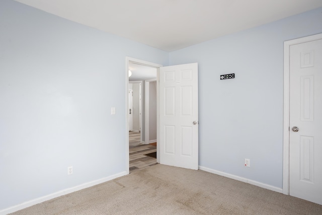 unfurnished bedroom featuring baseboards and carpet floors