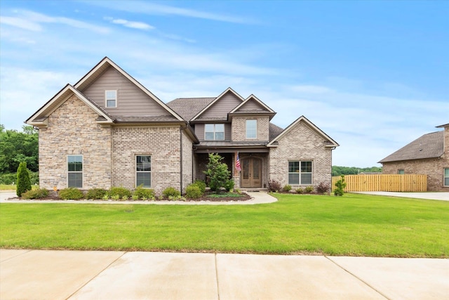 craftsman inspired home featuring brick siding and french doors