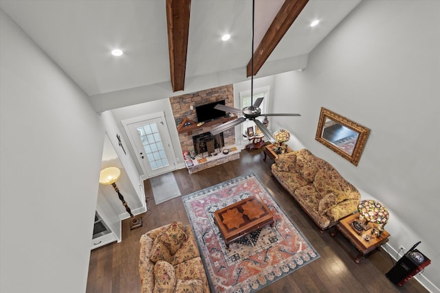 living room featuring beamed ceiling, recessed lighting, wood finished floors, and a fireplace