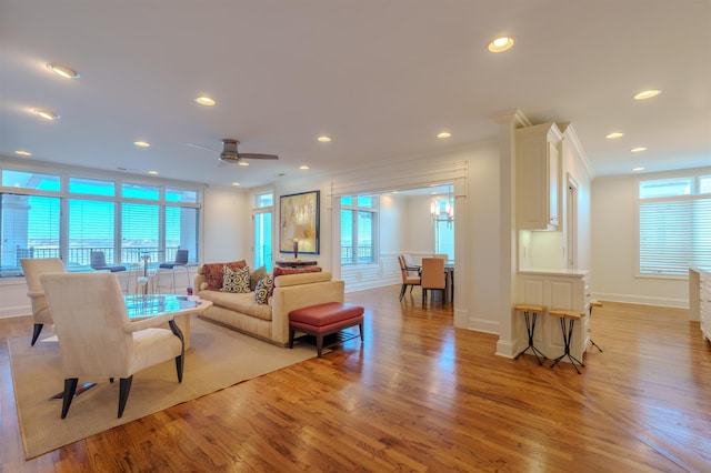 living room featuring ornamental molding, plenty of natural light, and light hardwood / wood-style flooring