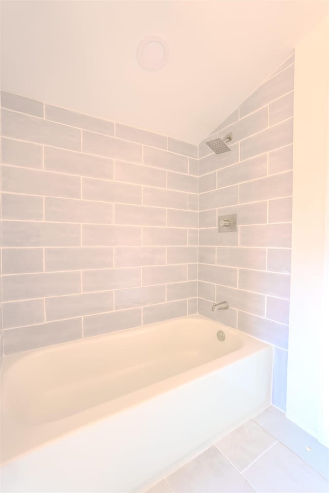  - full bath featuring lofted ceiling, shower / tub combination, and tile patterned floors