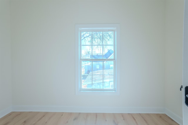  - empty room with light wood-type flooring and baseboards