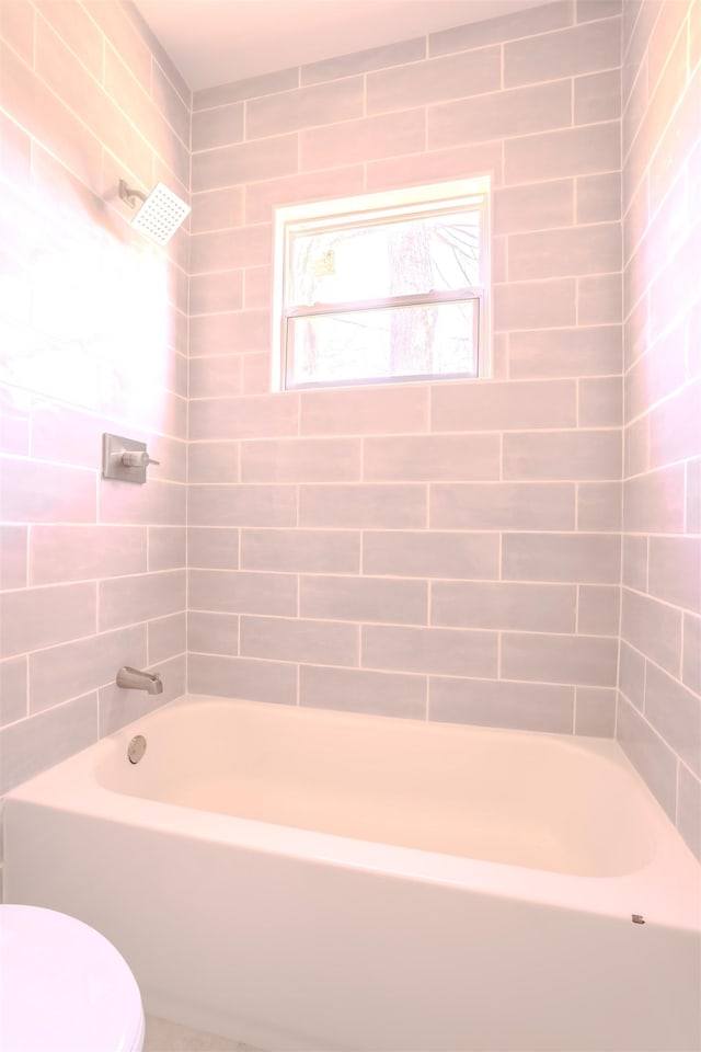 - bathroom featuring toilet and shower / tub combination