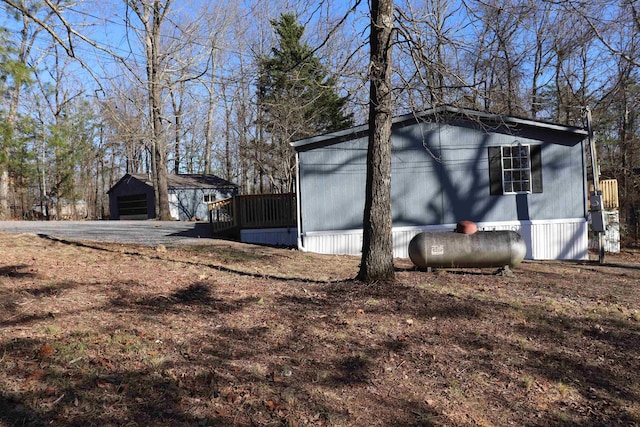 view of property exterior with an outdoor structure and a detached garage