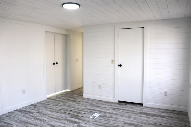 interior space featuring visible vents, baseboards, and wood finished floors