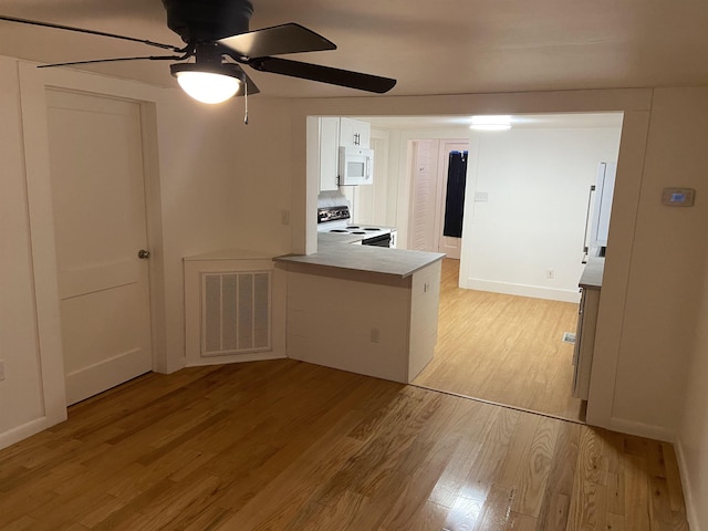 kitchen featuring kitchen peninsula, white appliances, ceiling fan, white cabinets, and light hardwood / wood-style floors