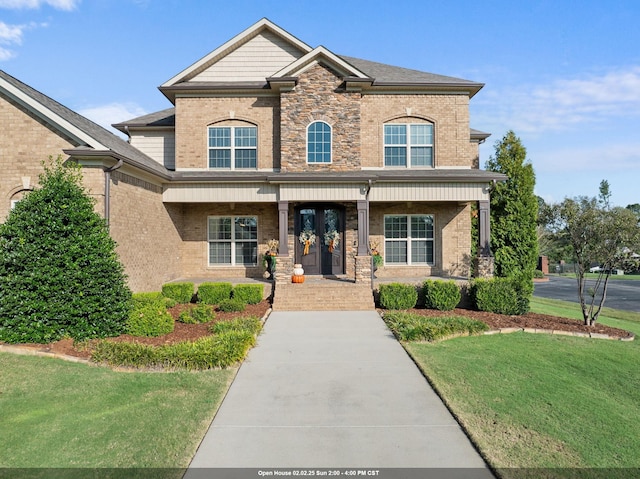 view of front of property with covered porch and a front lawn