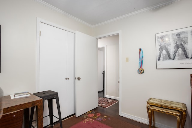 interior space featuring baseboards, crown molding, and wood finished floors