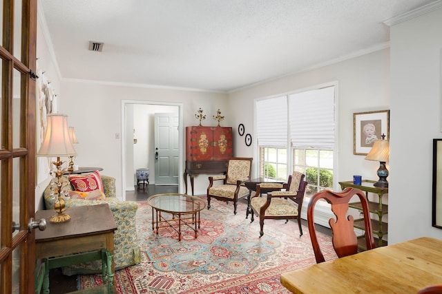 living area featuring crown molding and visible vents
