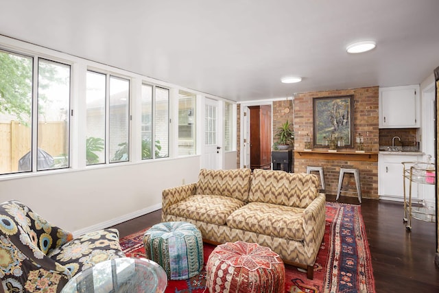 living room with dark wood-style flooring and baseboards