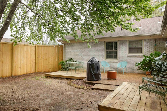 view of yard featuring a deck and fence