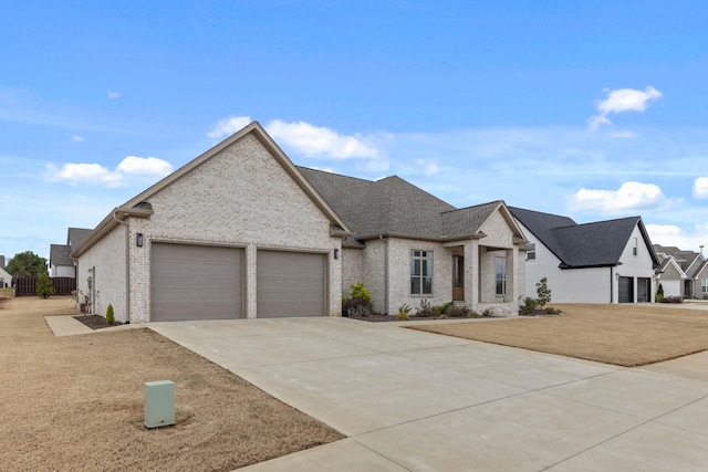 view of front of home with a garage, brick siding, and driveway