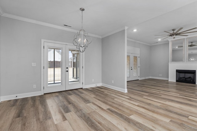 unfurnished living room featuring french doors, baseboards, wood finished floors, and a fireplace