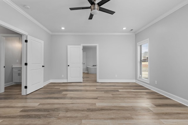 unfurnished bedroom with baseboards, recessed lighting, ornamental molding, light wood-style floors, and connected bathroom