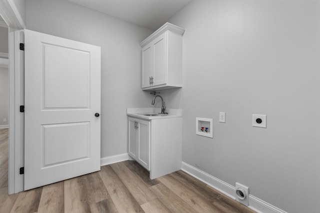 laundry area with electric dryer hookup, light wood-style flooring, a sink, baseboards, and hookup for a washing machine