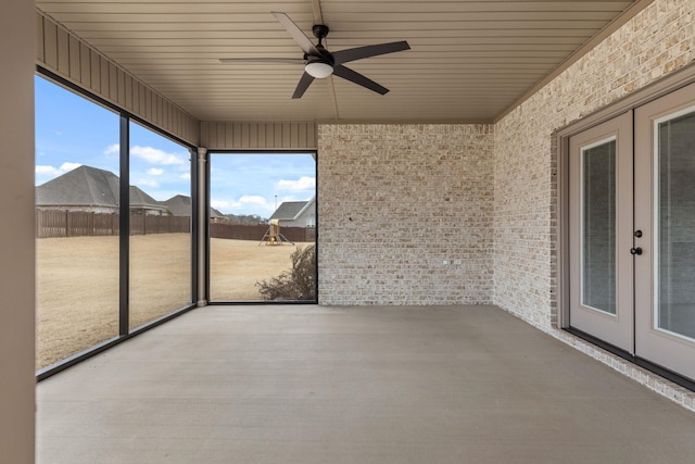 unfurnished sunroom featuring french doors and ceiling fan