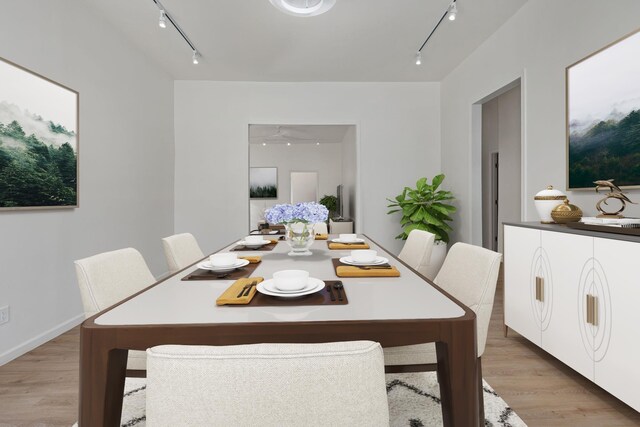  - dining area featuring track lighting and light wood-type flooring