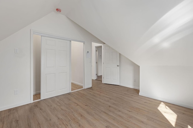  - additional living space featuring wood finished floors, vaulted ceiling, and baseboards
