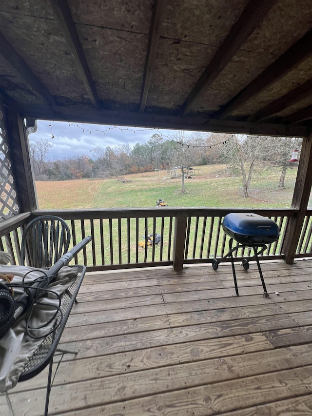 wooden terrace featuring a lawn and area for grilling