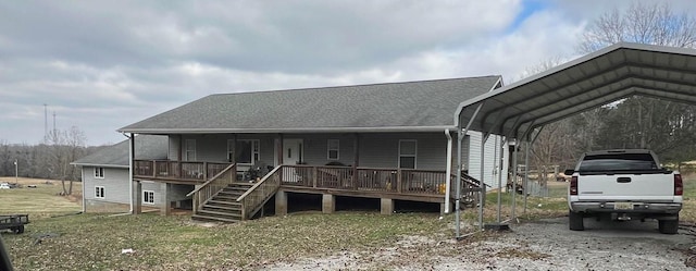 view of front of property with covered porch, a carport, and stairs