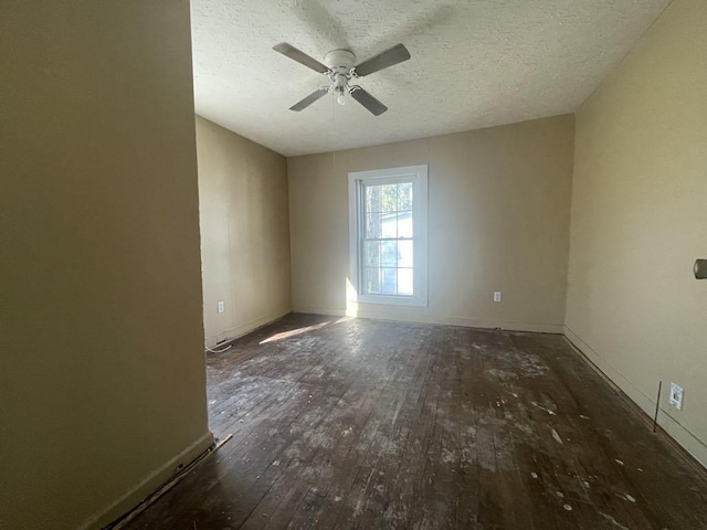 unfurnished room featuring dark hardwood / wood-style flooring, ceiling fan, and a textured ceiling