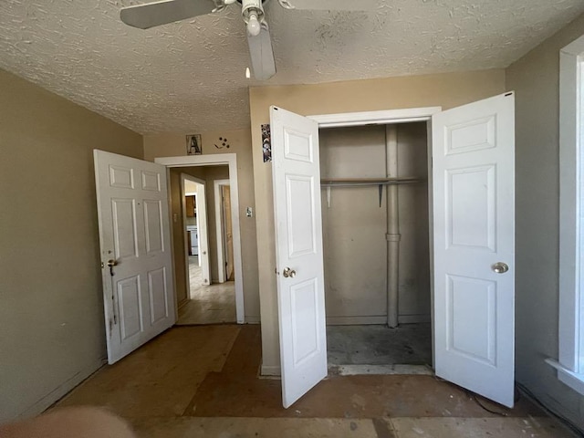 unfurnished bedroom with ceiling fan, a closet, and a textured ceiling