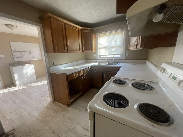 kitchen featuring electric stove, sink, a textured ceiling, and range hood