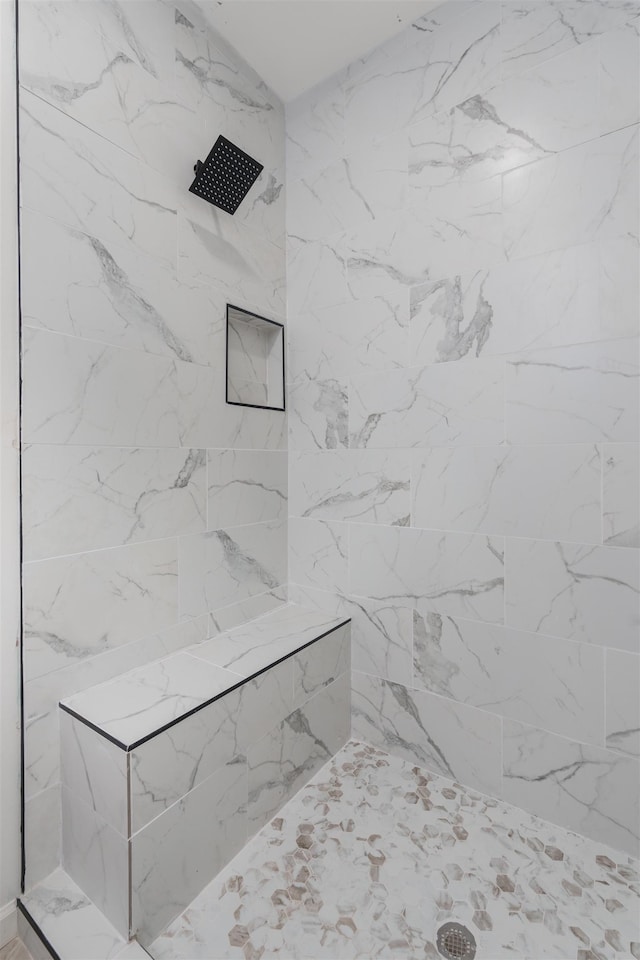  - bathroom featuring tiled shower