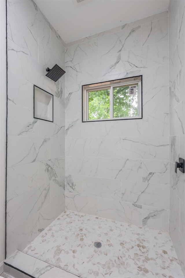  - bathroom featuring tiled shower