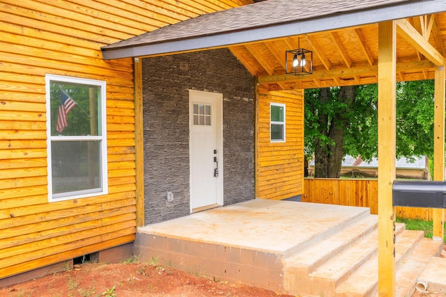  - entrance to property with roof with shingles