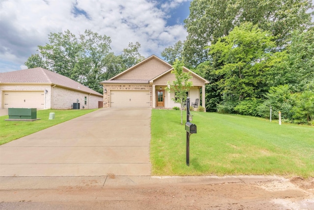 181 Silver Leaf Ln, Florence, AL - view of front of property with a front yard, concrete driveway, brick siding, and an attached garage