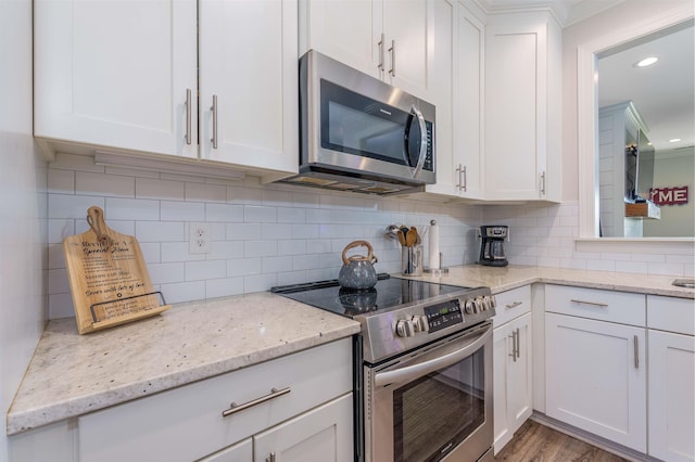 181 Silver Leaf Ln, Florence, AL - kitchen featuring appliances with stainless steel finishes, white cabinets, backsplash, light stone countertops, and recessed lighting