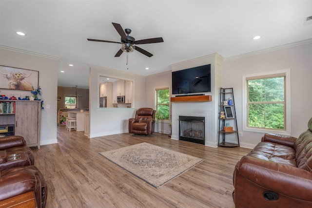 181 Silver Leaf Ln, Florence, AL - living area featuring crown molding, a fireplace, a ceiling fan, light wood-type flooring, and recessed lighting