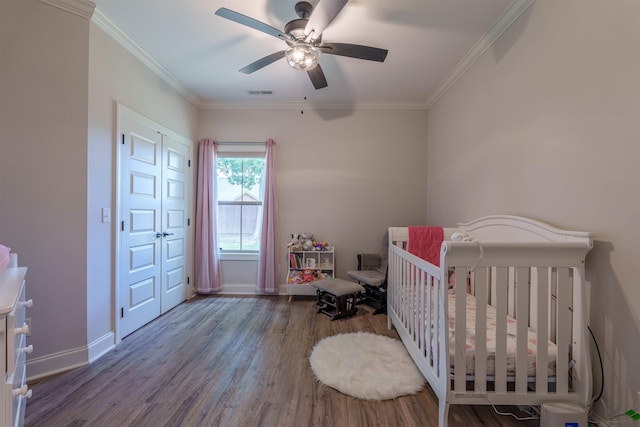 181 Silver Leaf Ln, Florence, AL - bedroom featuring wood finished floors, ornamental molding, a nursery area, and ceiling fan